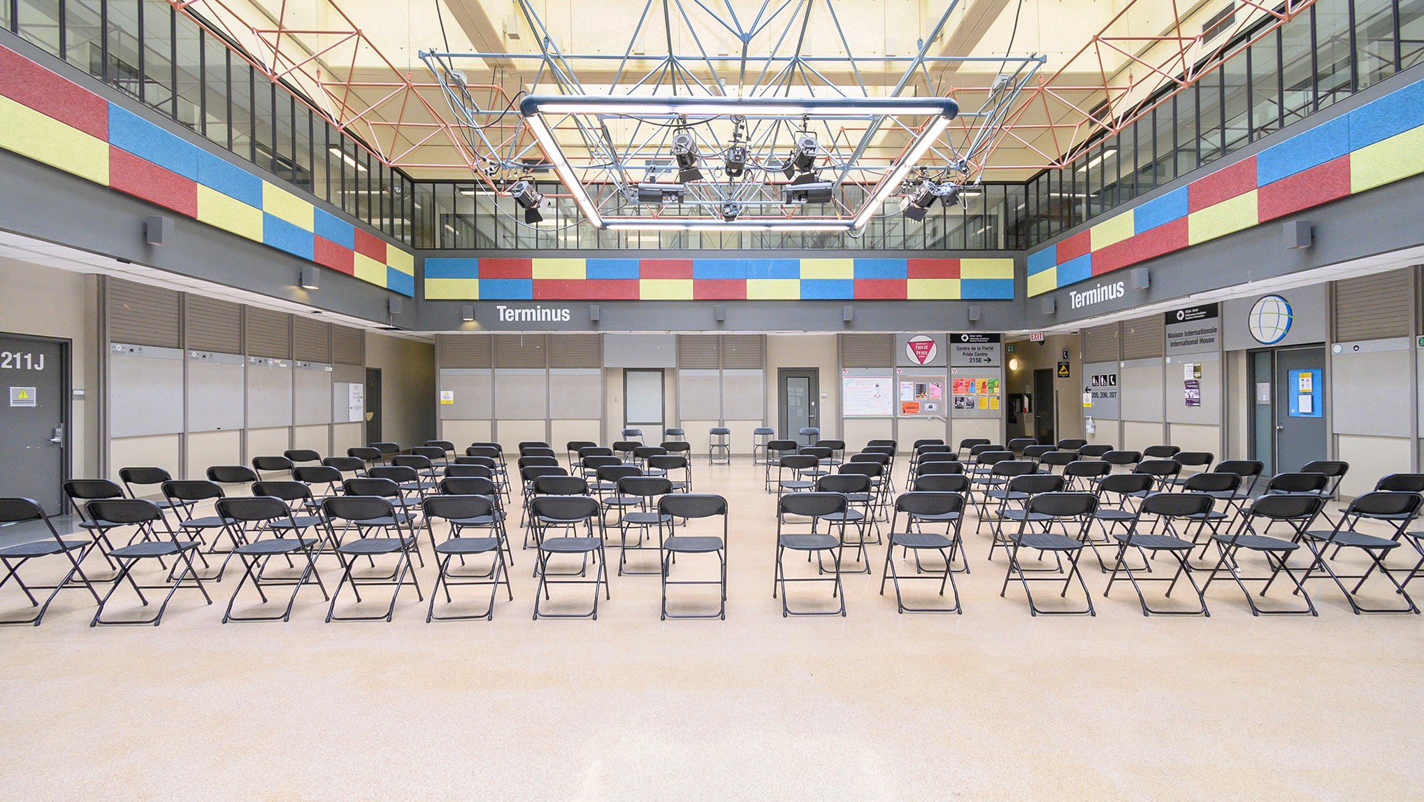 Terminus space with empty chairs set up, from back of room.