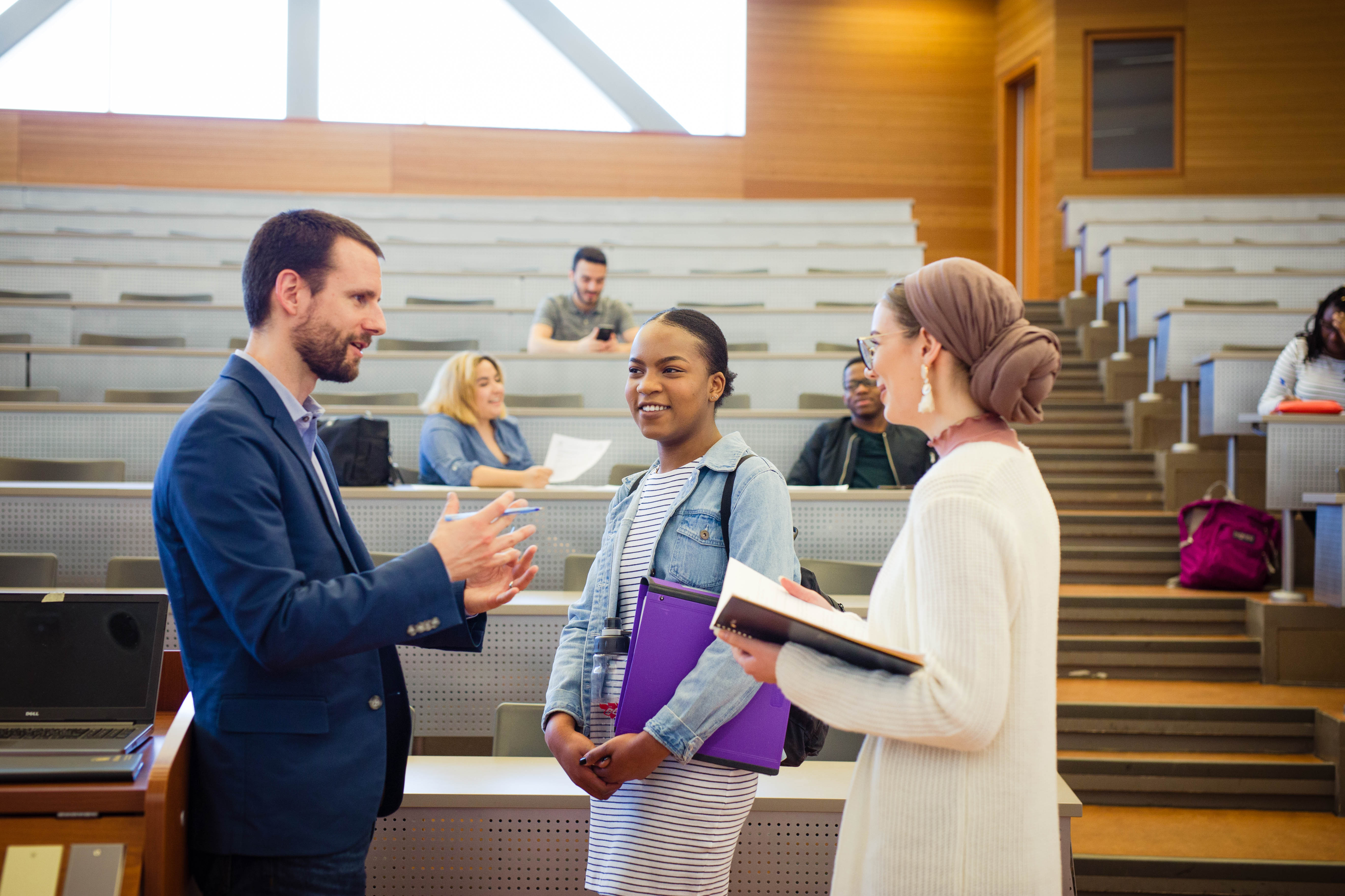 A professor talking to two students.