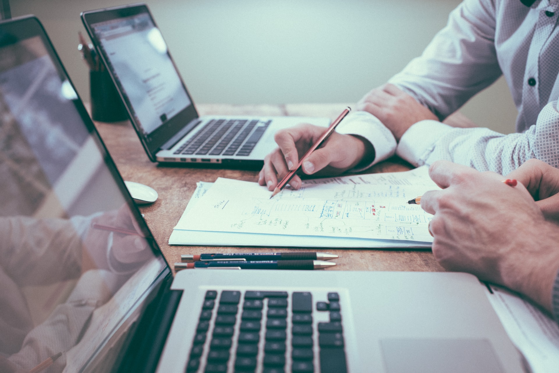 two people working on financial planning sheets