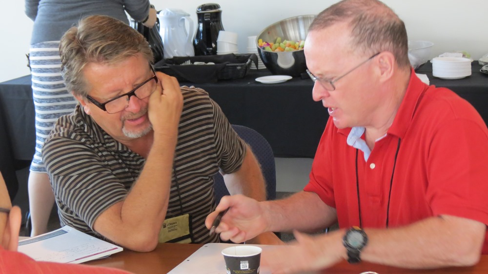 Two people talking to each other at a table