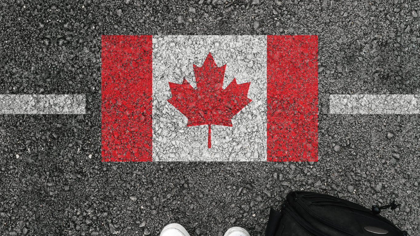 Canadian flag spray painted on the ground.