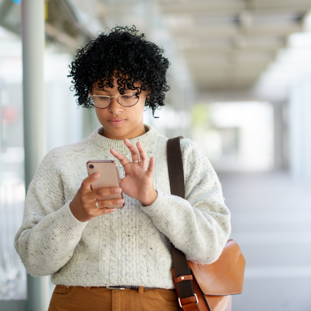 Student looking at cellphone outside