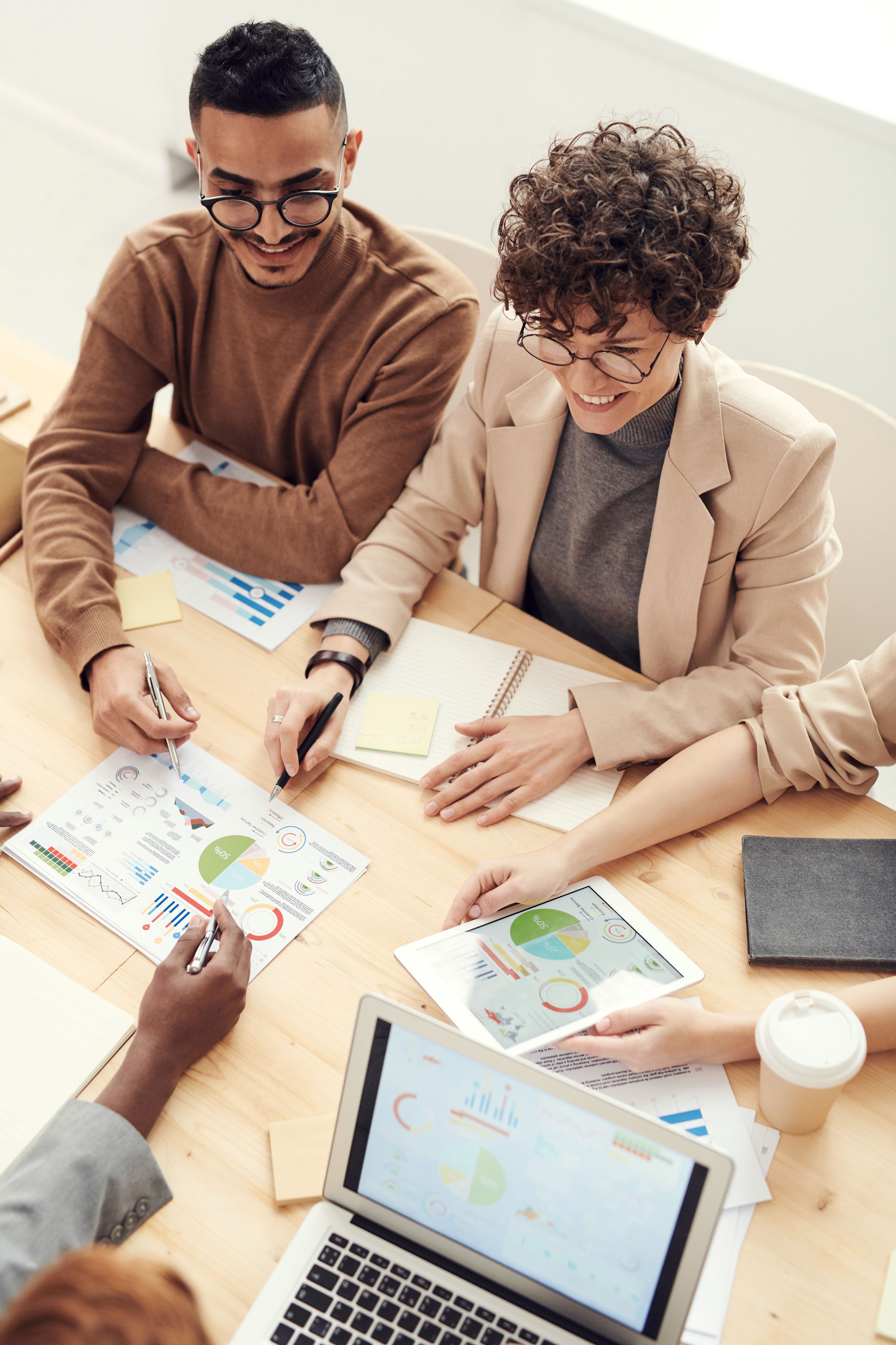 A small group of business people work on a project together at a table