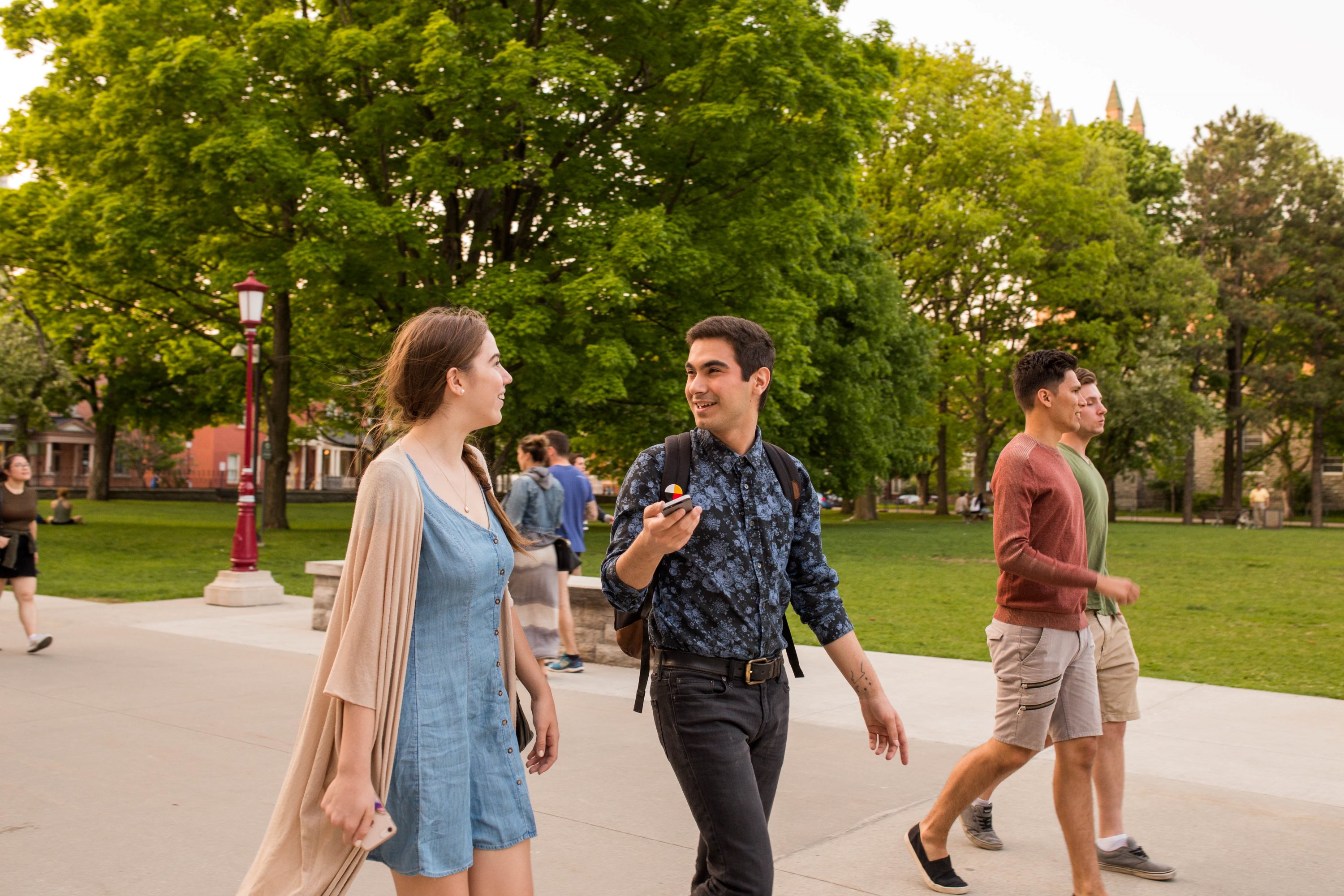 Two students talking to each other on campus.