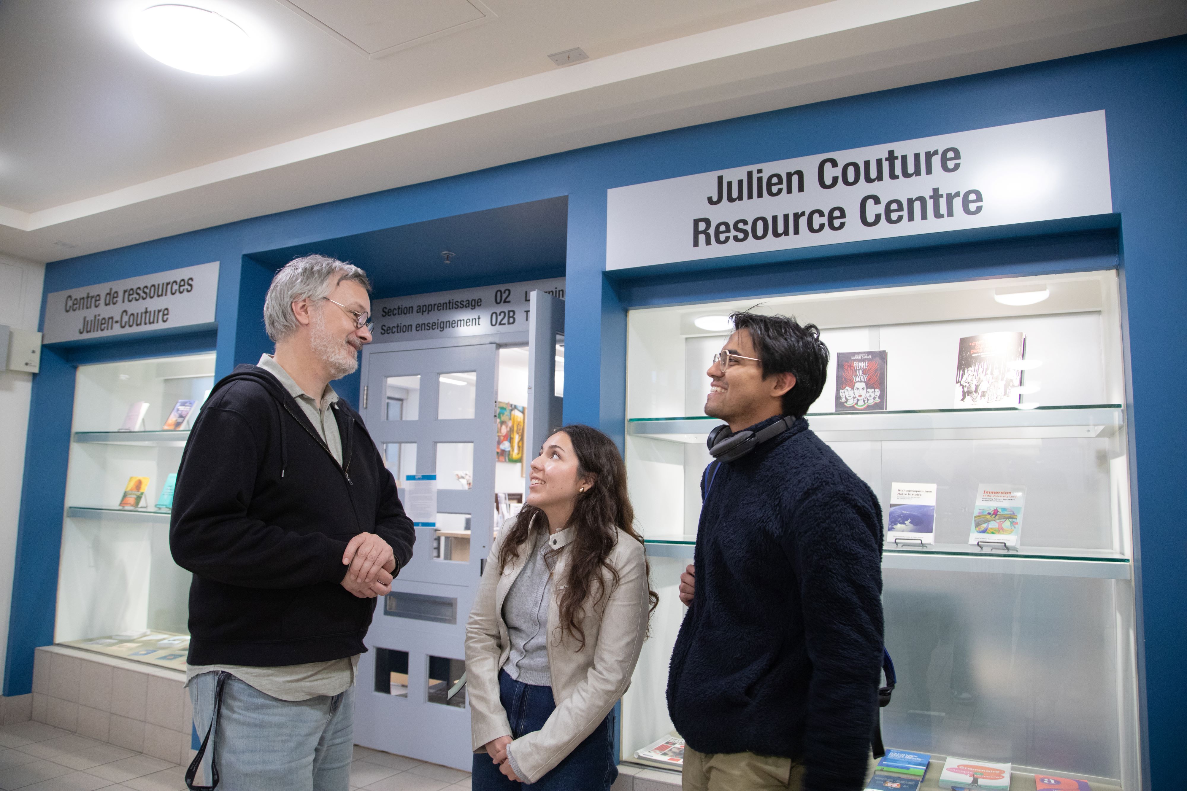 3 people talking outside the Julien Couture Resource Centre