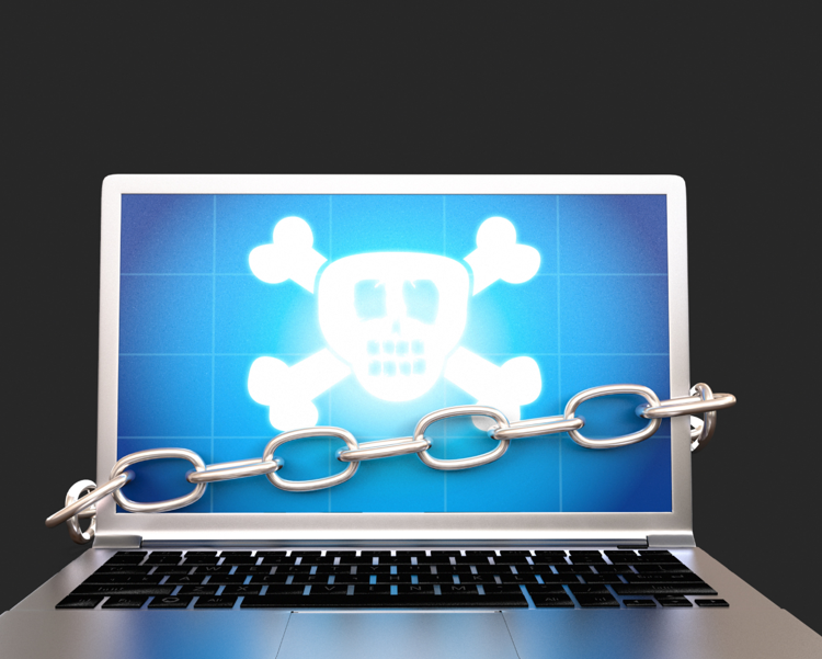 A skull on laptop screen, the laptop is surrounded by a chain