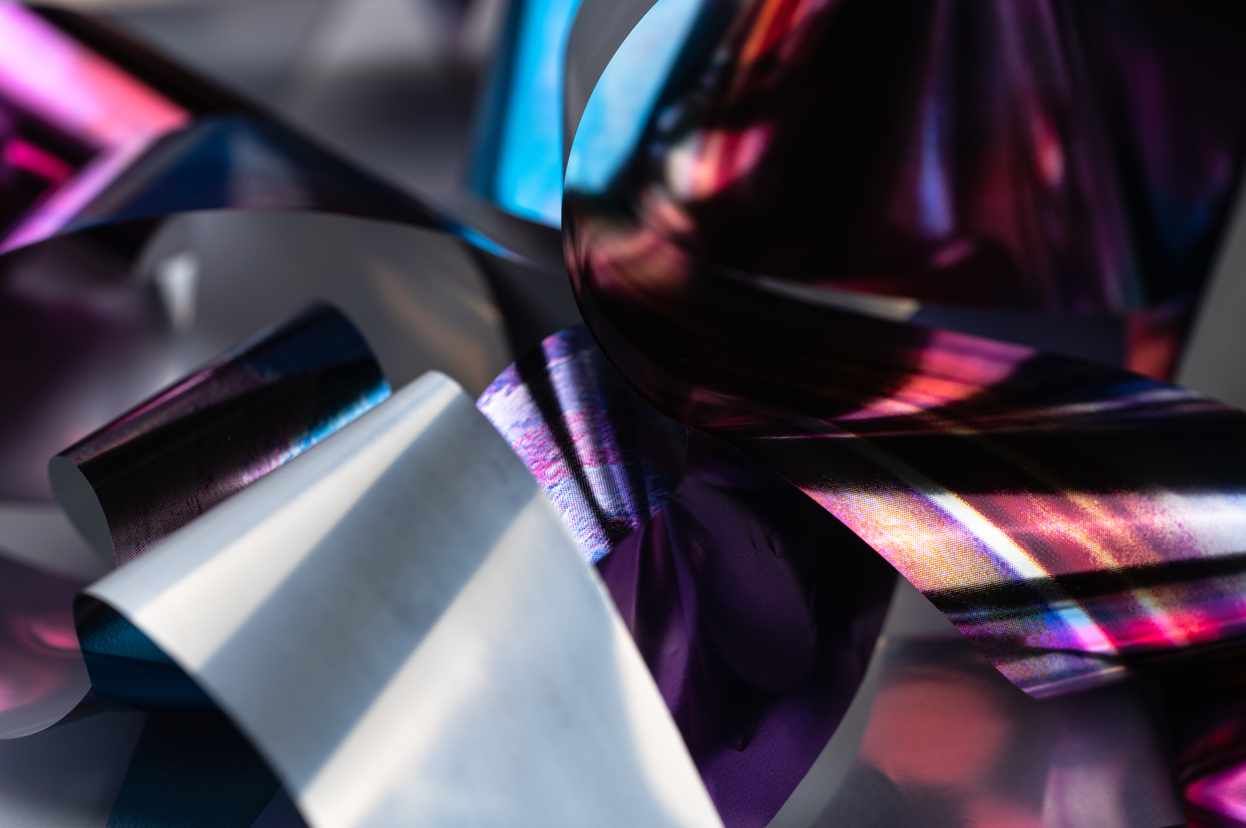 sheets of metal randomly arranged inside a multicolored filter 