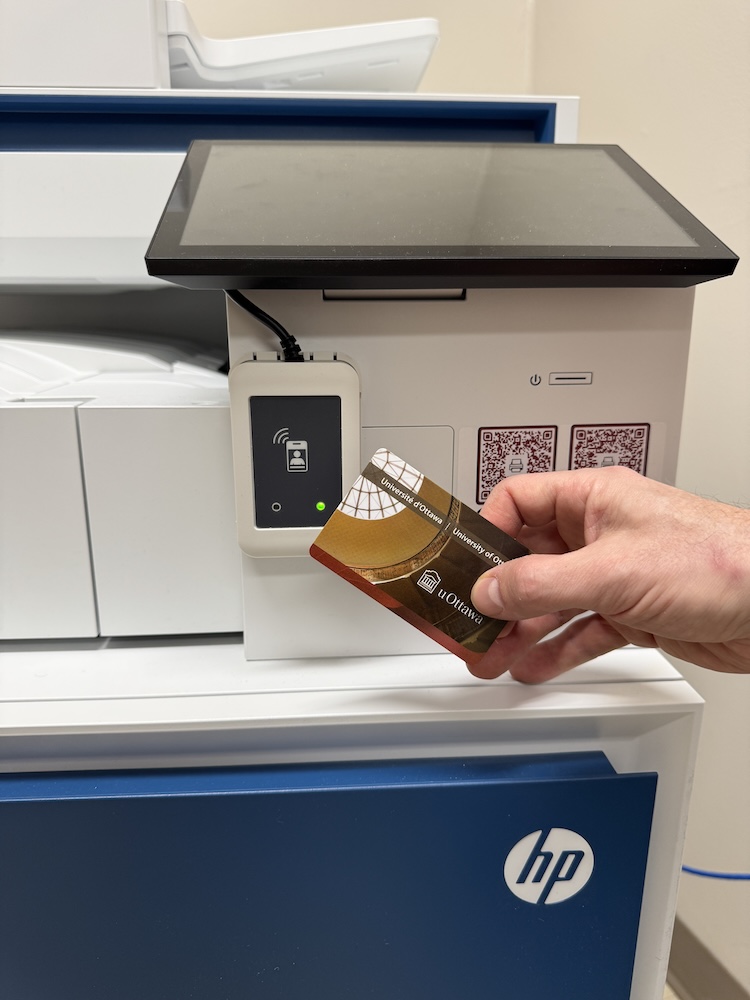 Picture of the visitors printing card next to a brand new uottawa HP printer