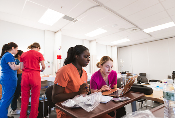 Med students looking at a laptop