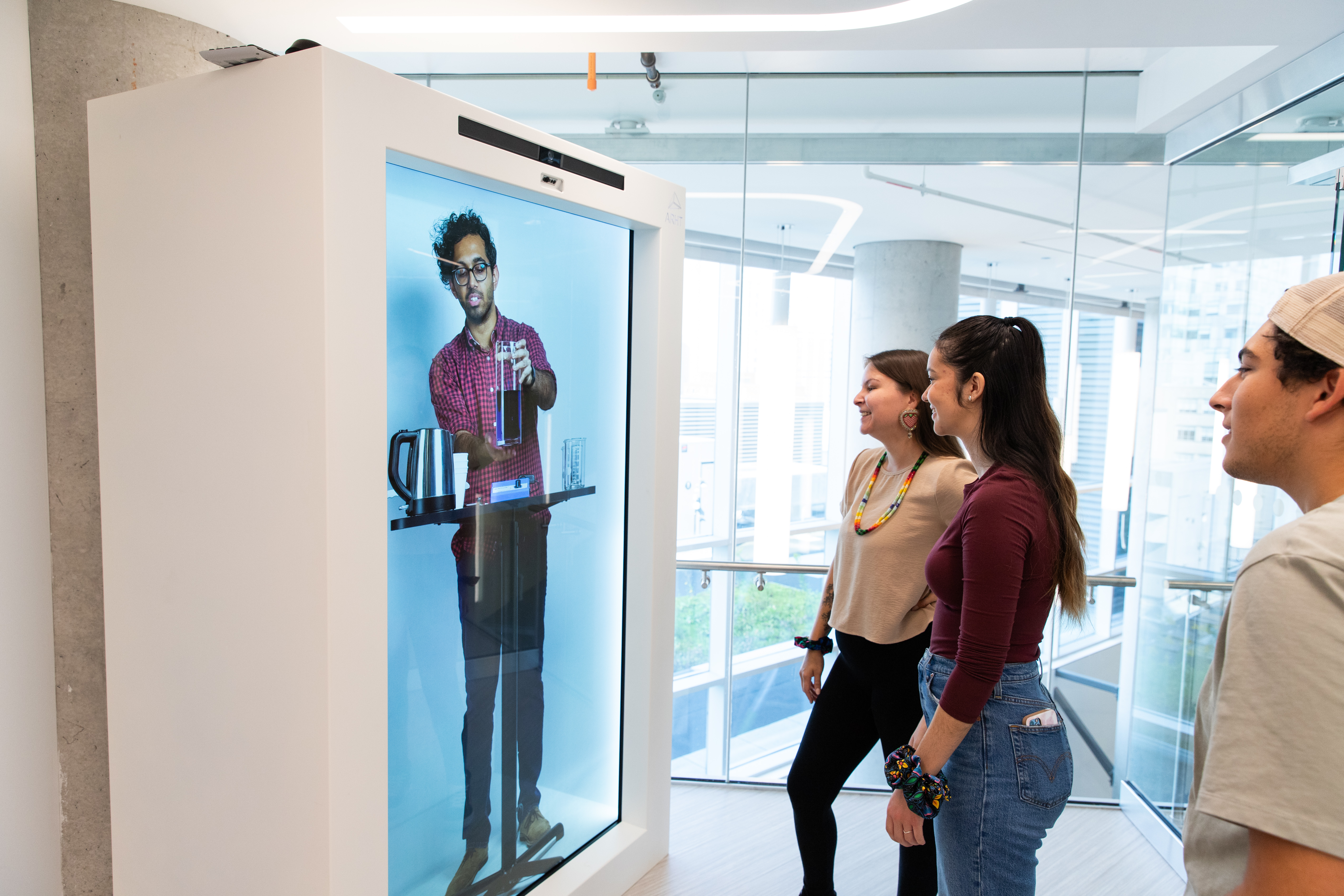 student looking at the hologram box screen