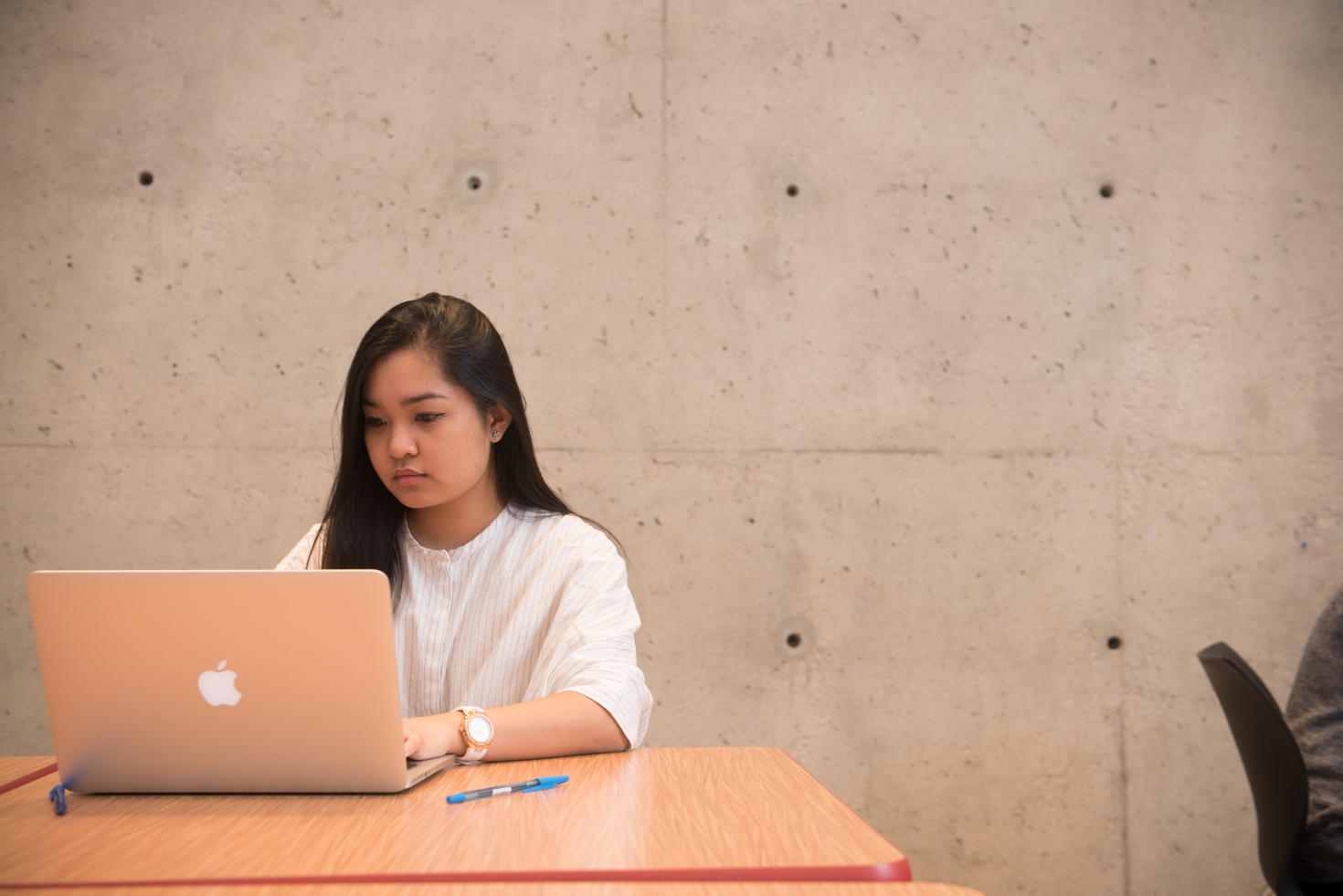 person working in collaborative space on laptop
