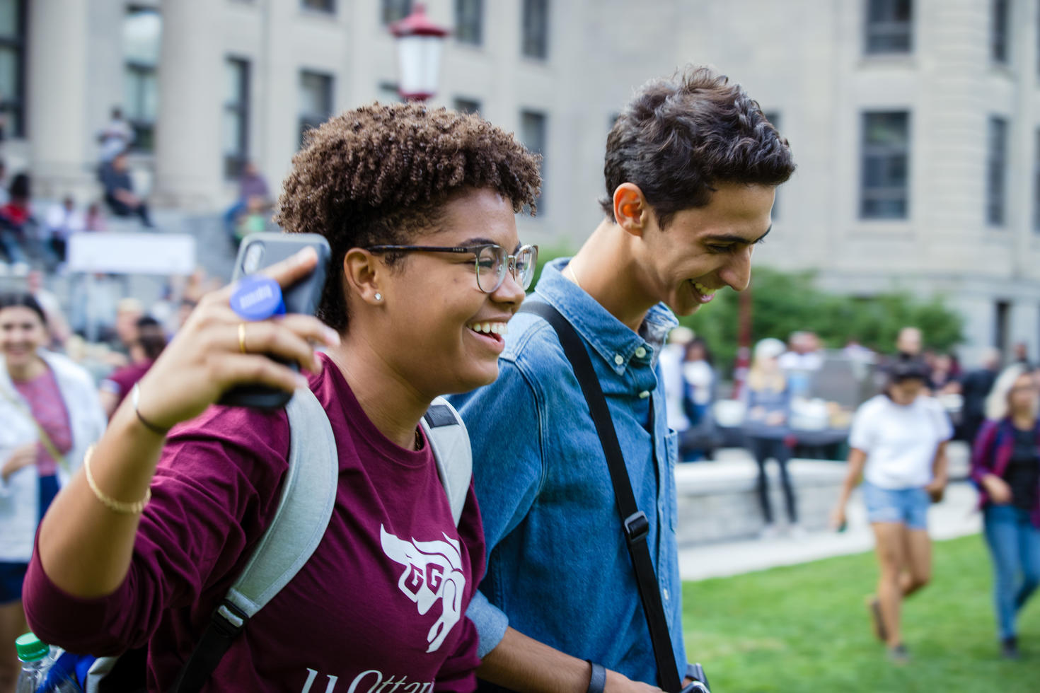Students walking around campus laughing.