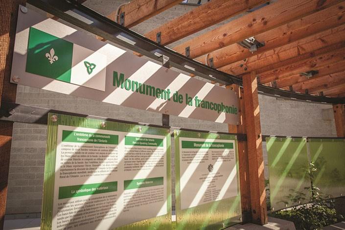 "Monument de la francophonie" informational sign in building. 