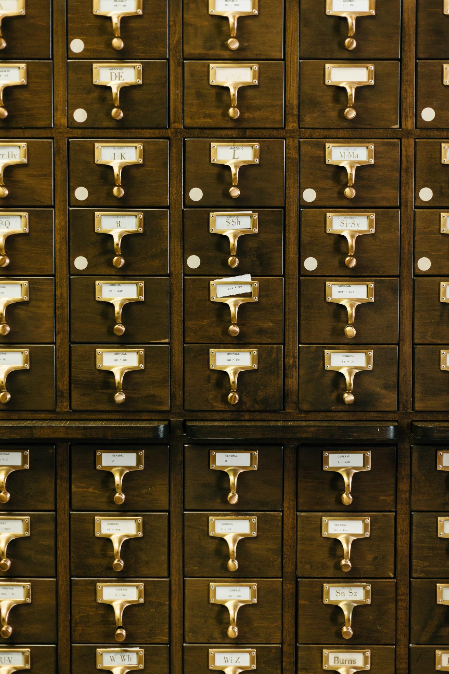 Wood drawers with gold label plates.