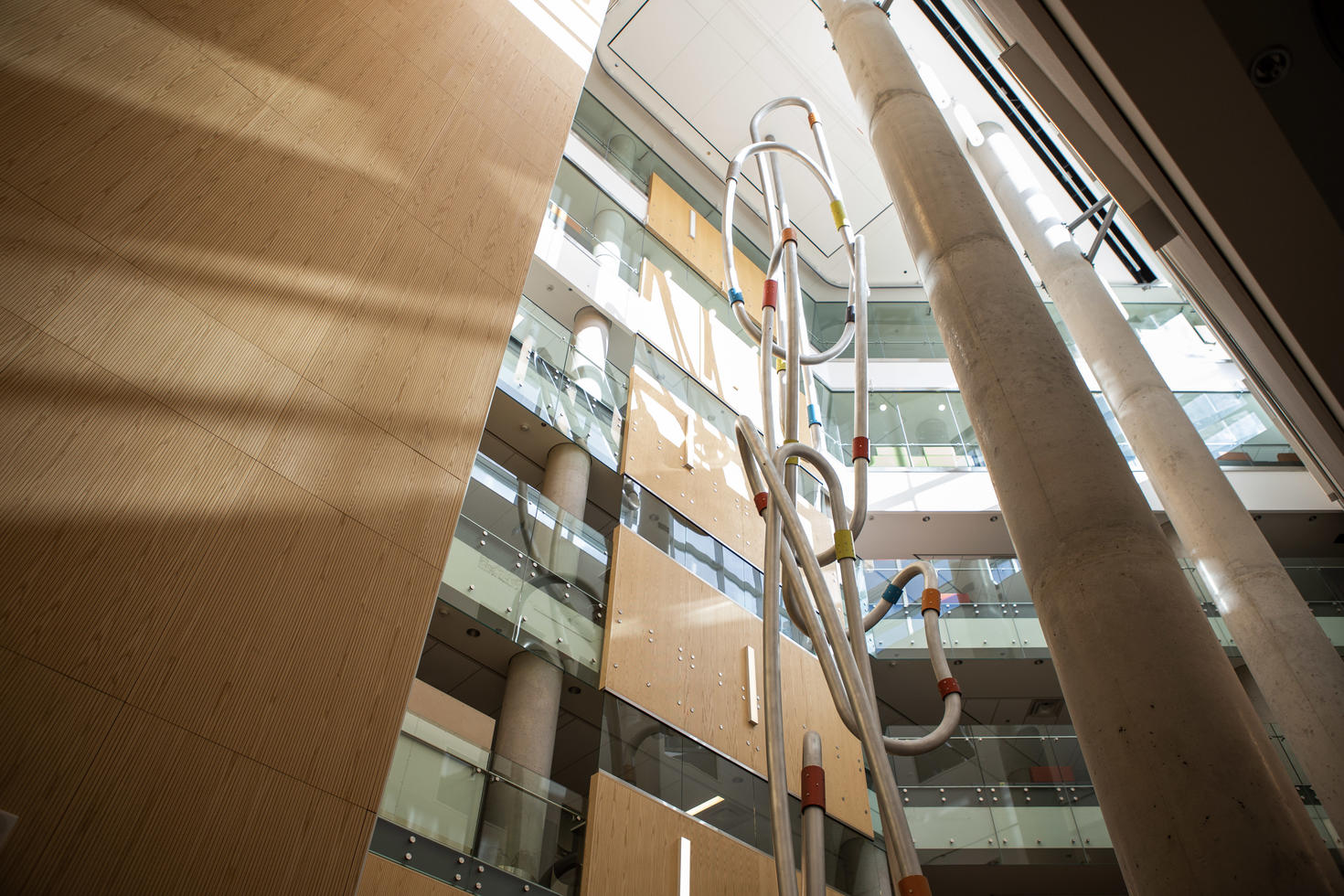 Abstract sculpture in hallway of campus building.
