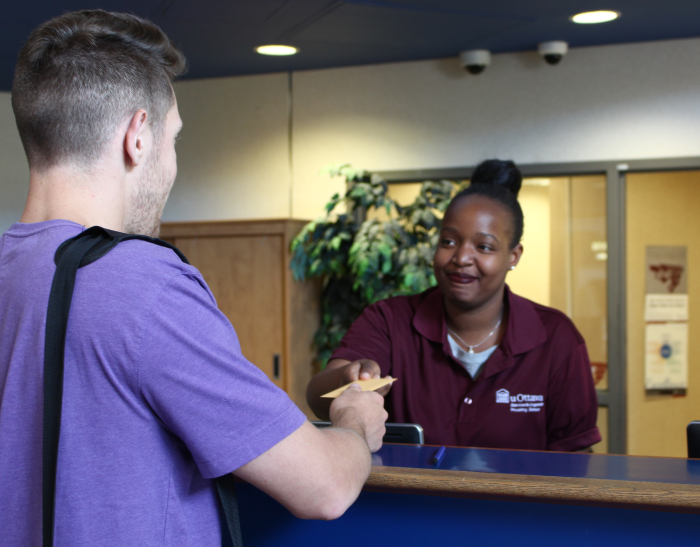 Person checking in at client service desk.