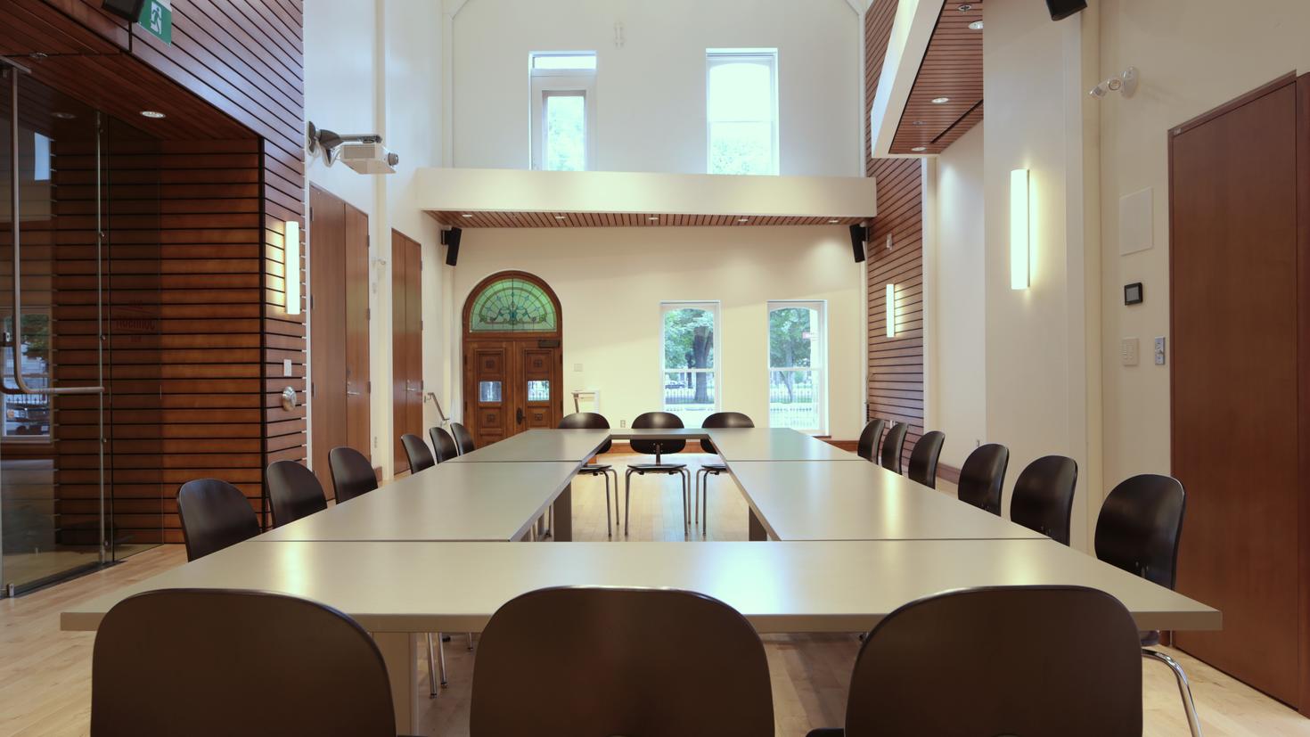 belairdirect Hall, empty with large table and chairs in middle of room.