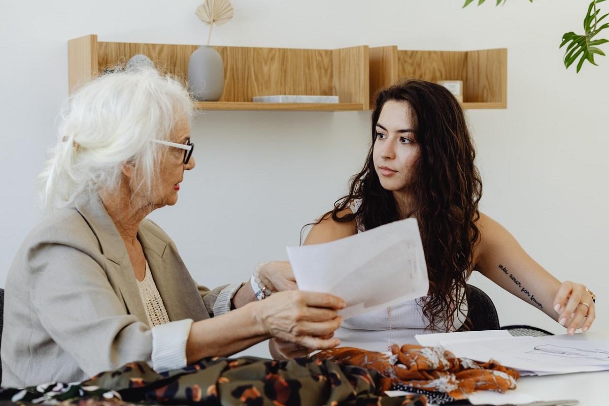 Elder woman and young woman discussing something