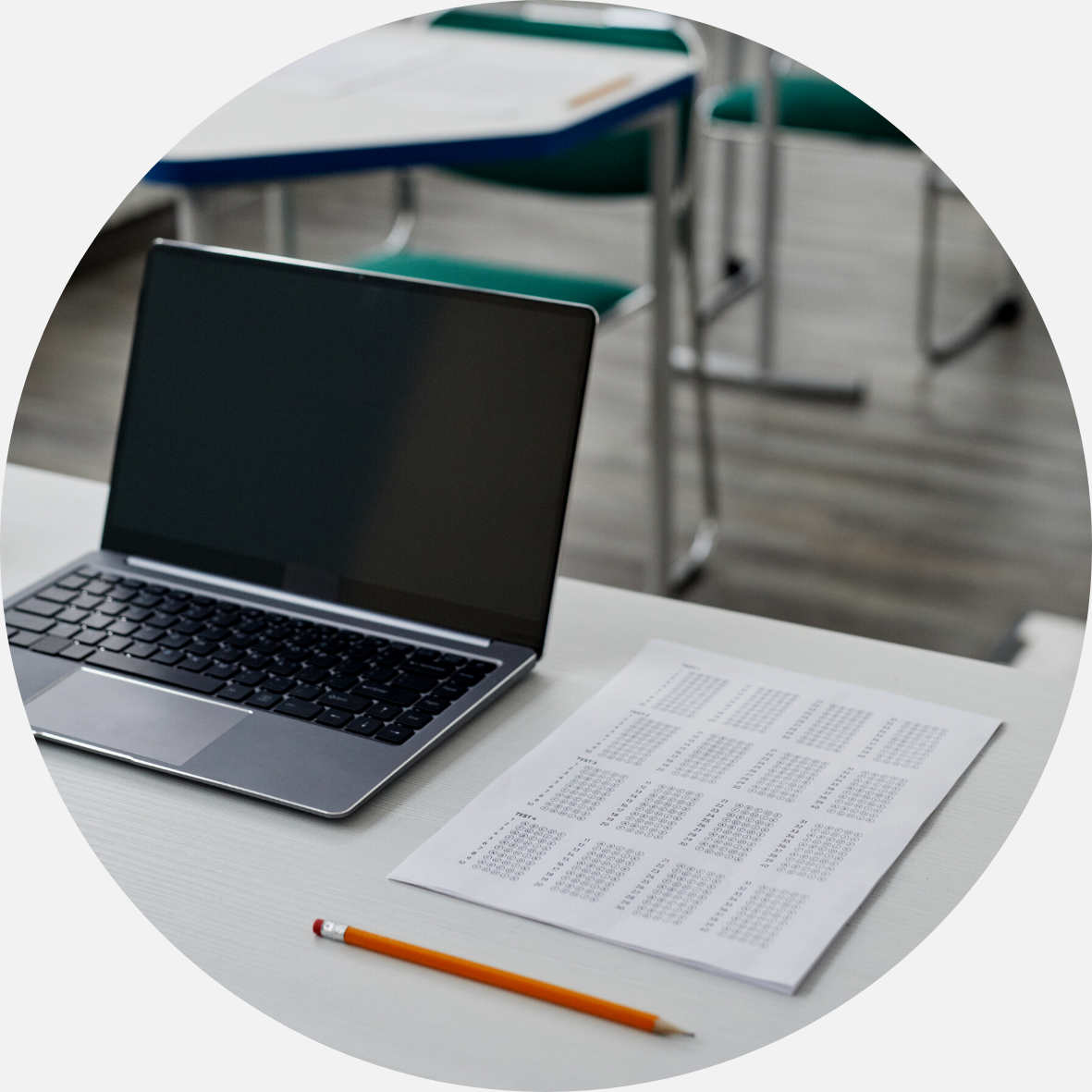 Laptop with a test and a pencil beside it