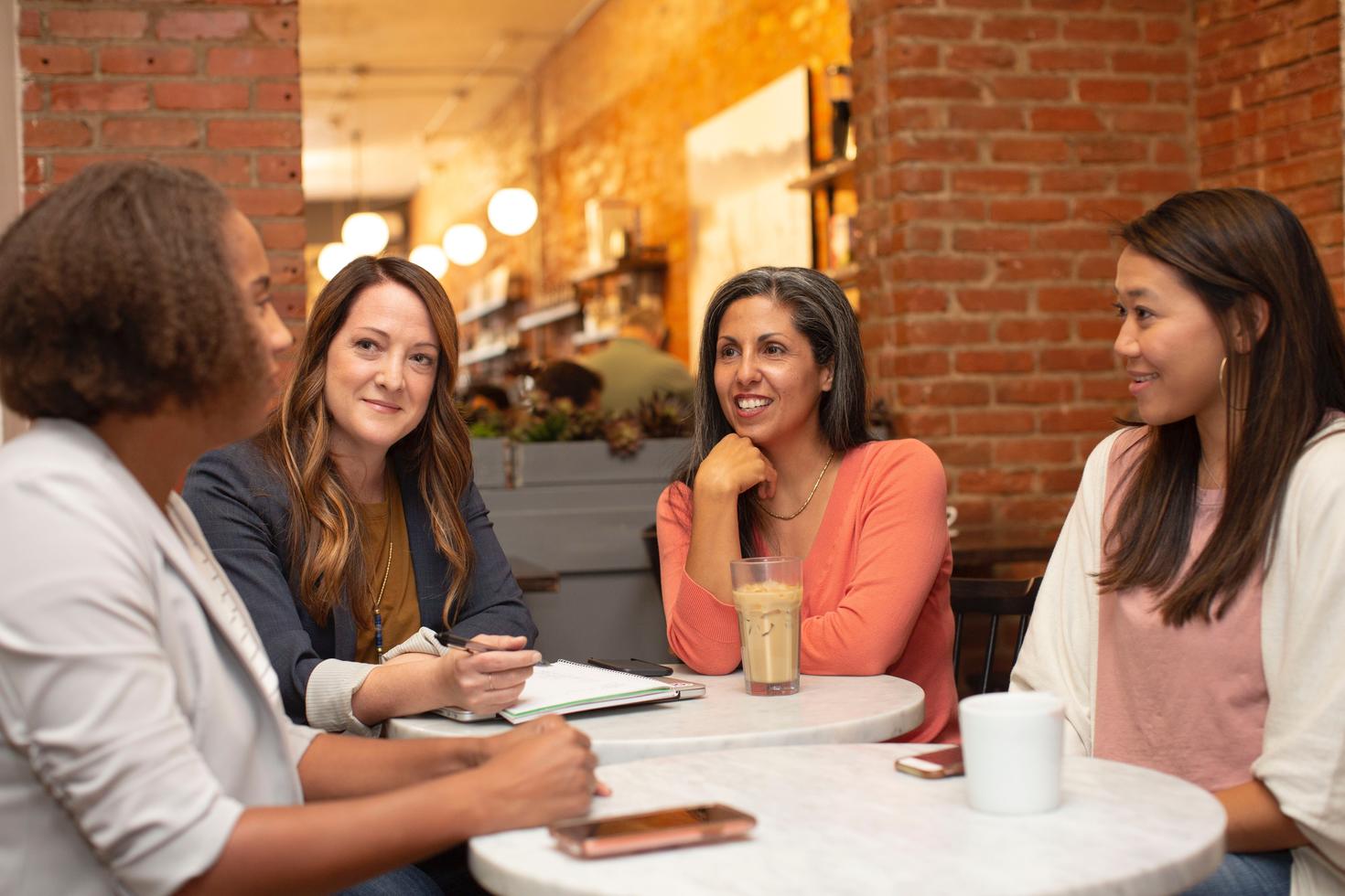 women talking around table