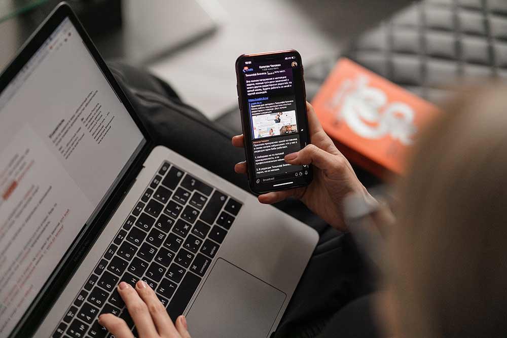 person looking at newsletter on phone