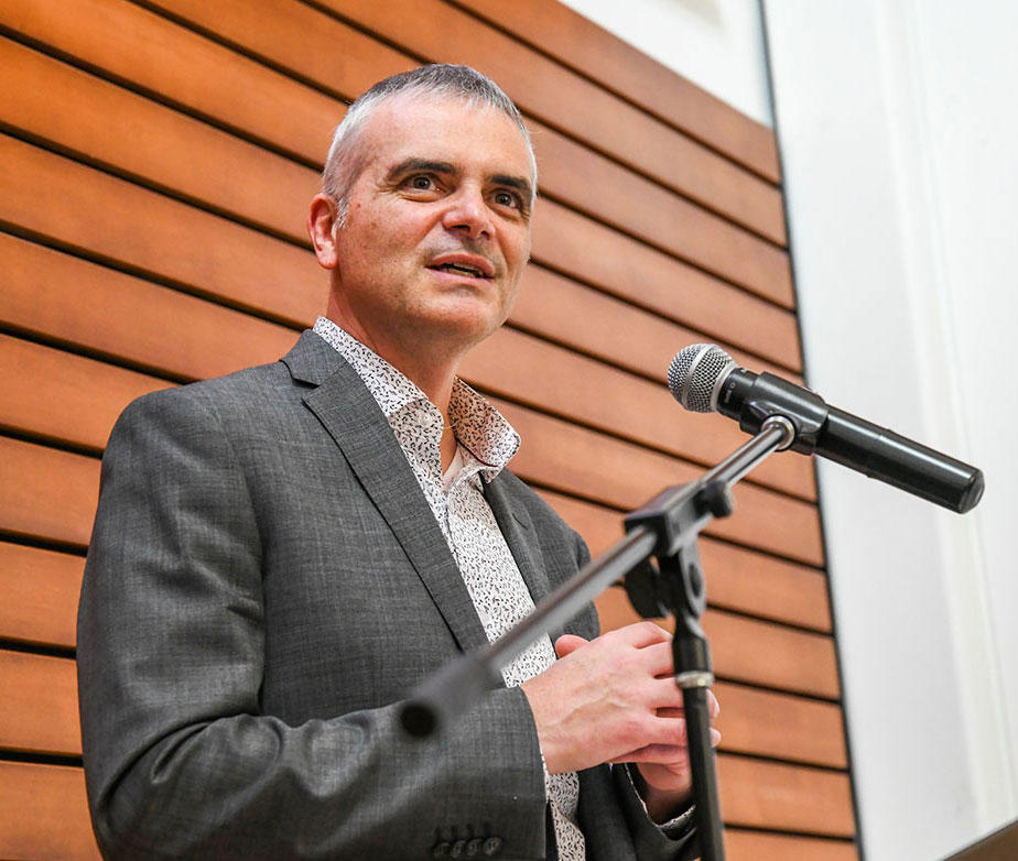 Martin Bernier speaking into a microphone. 