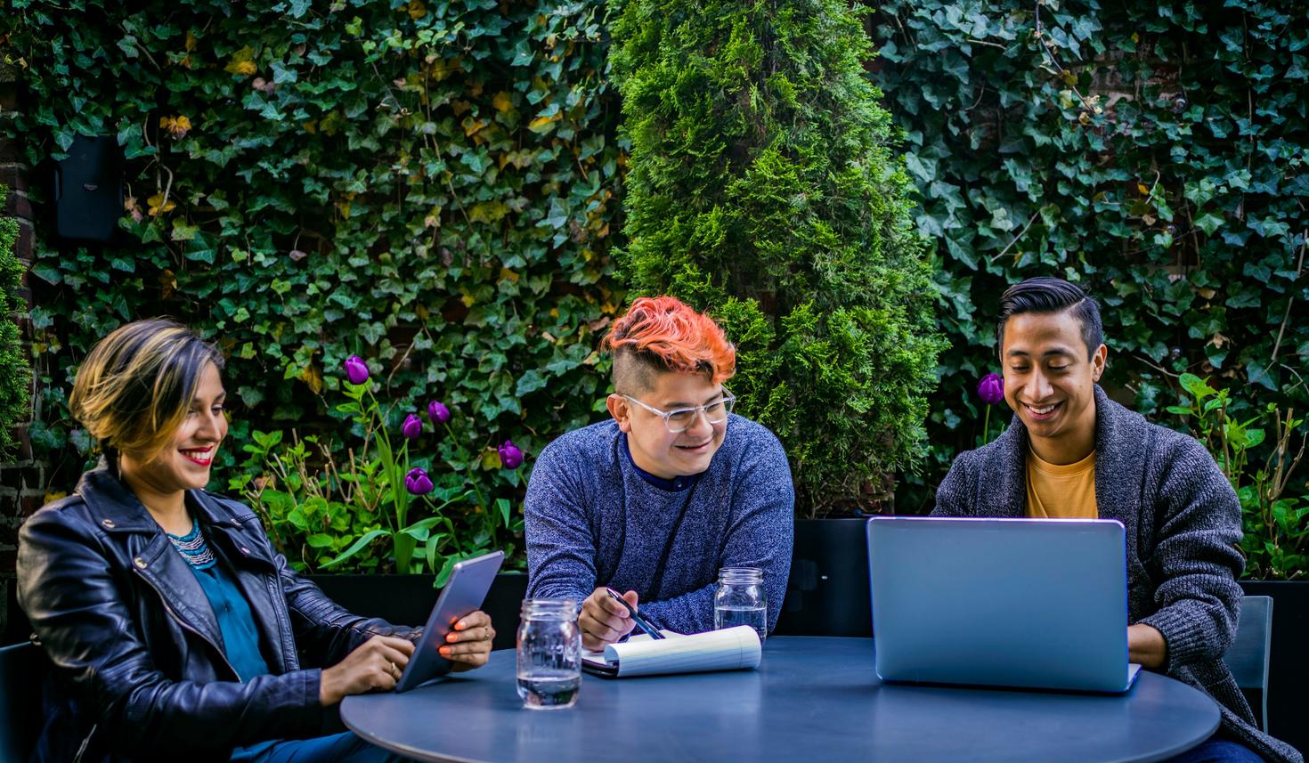 People sitting at a table with a laptop