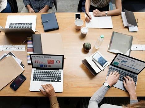 Small team collaborating at a table.