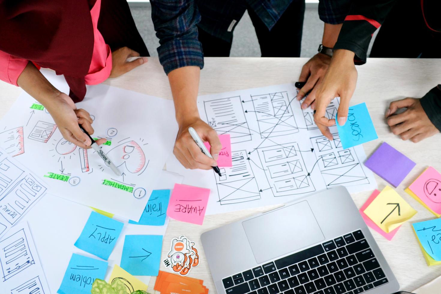 People writing on post - it notes