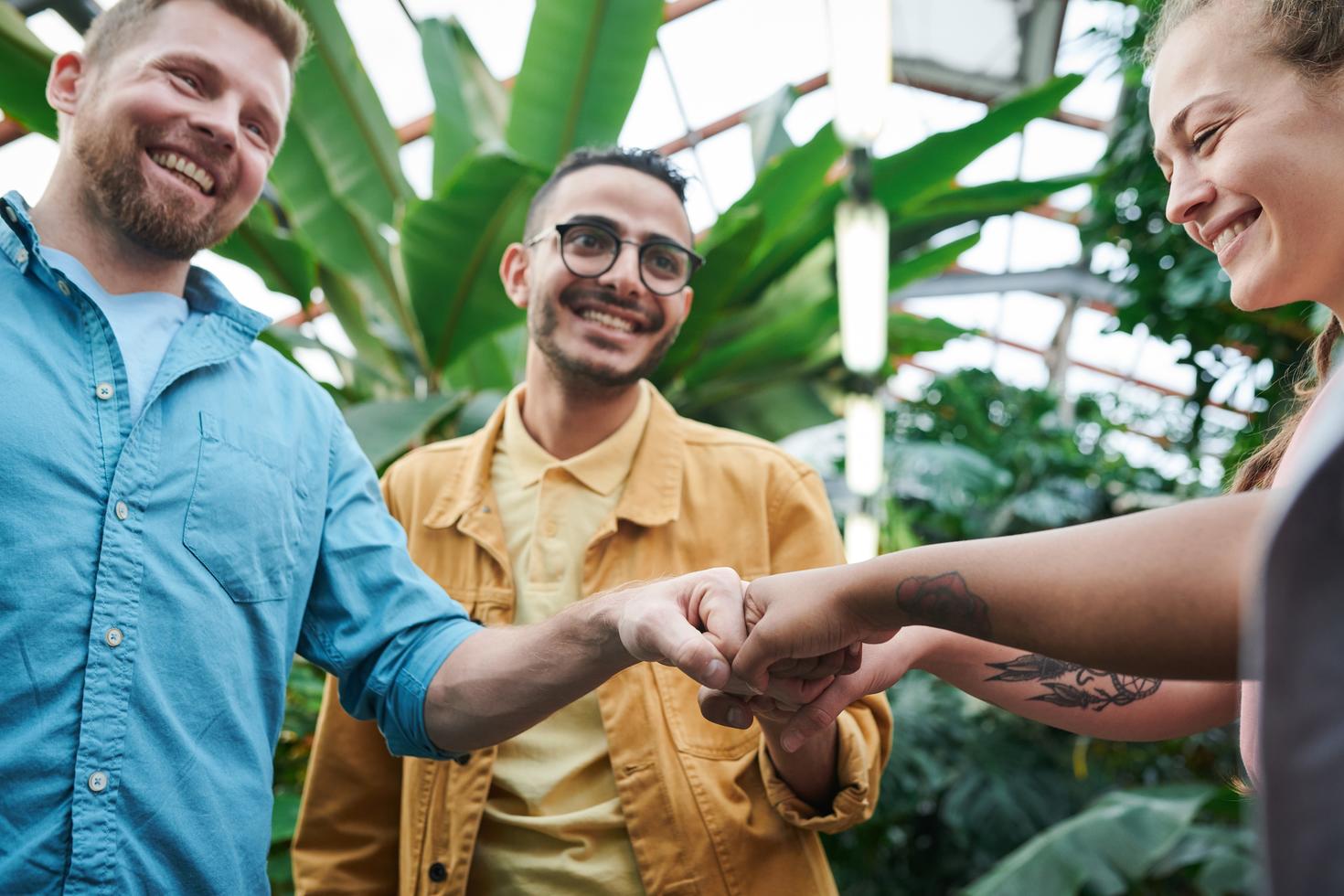 A group of people fist-bumping