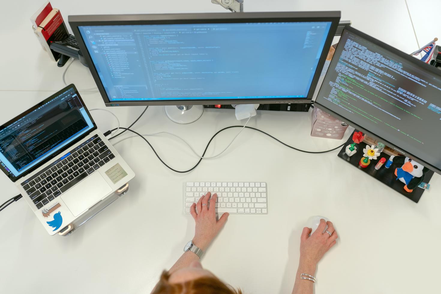 Computer station with three monitors. 