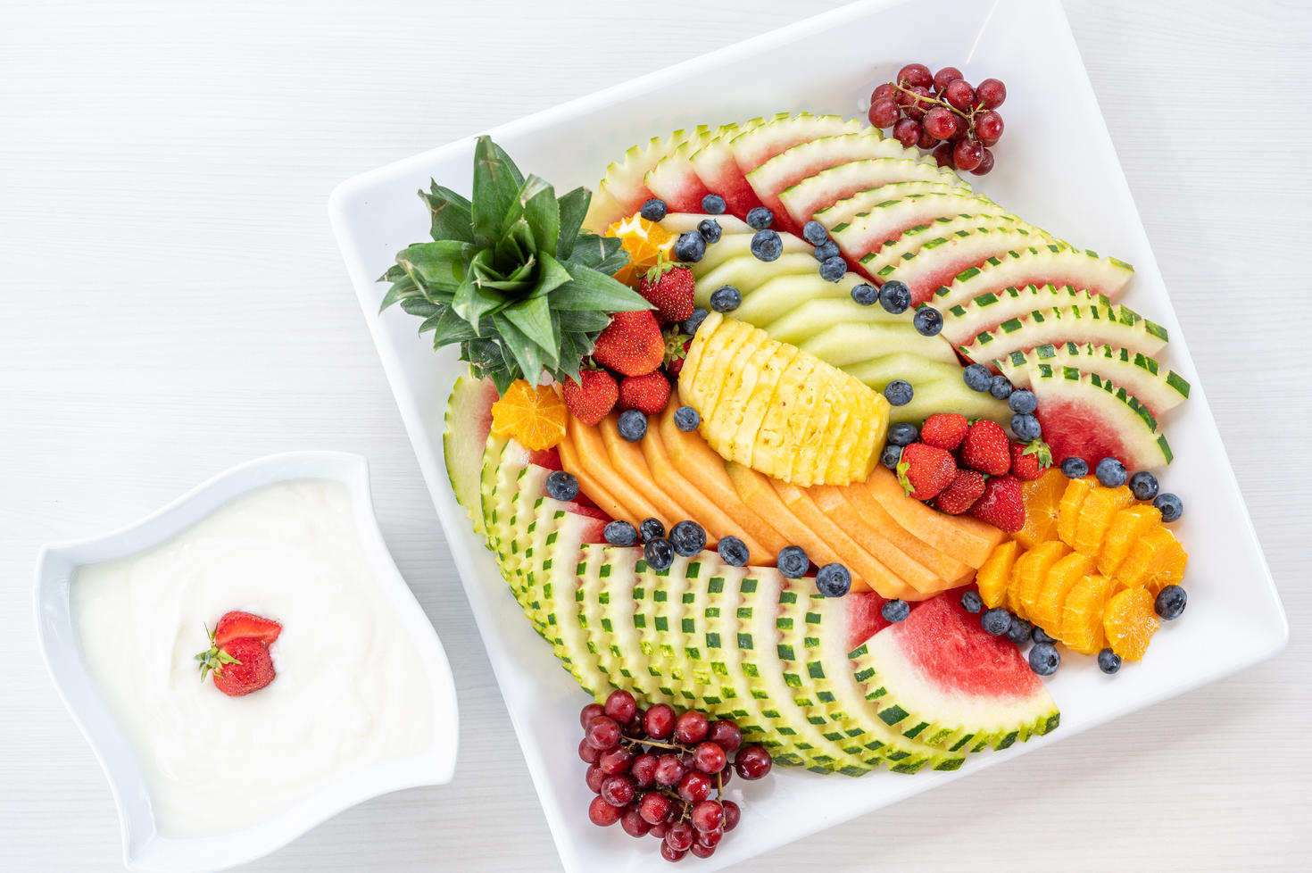 fruit platter with yogurt on the side