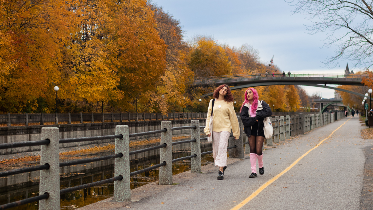 View of two students walking on the Rideau Canal 