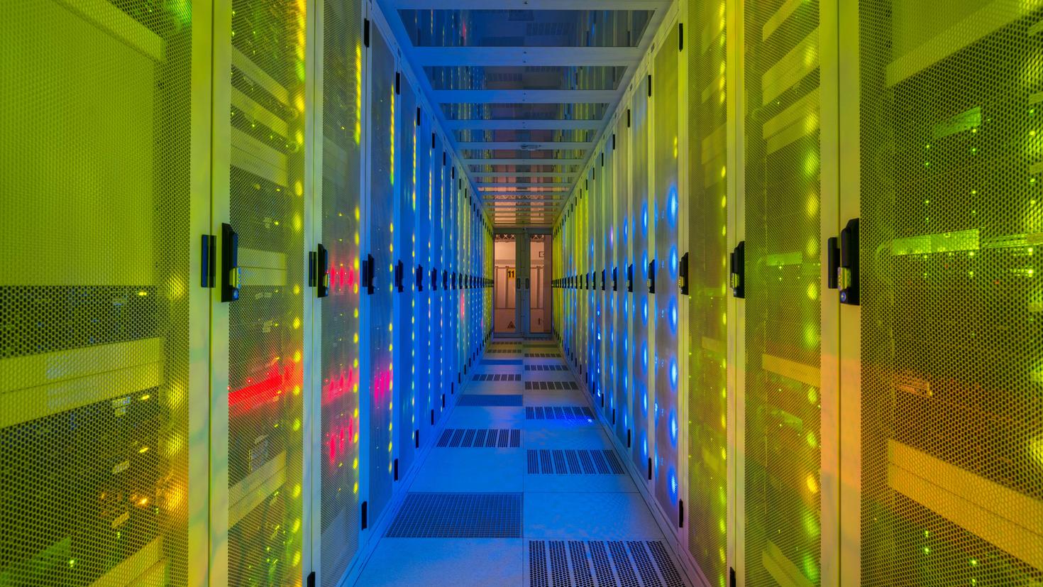 A data centre server room with colorful lights.