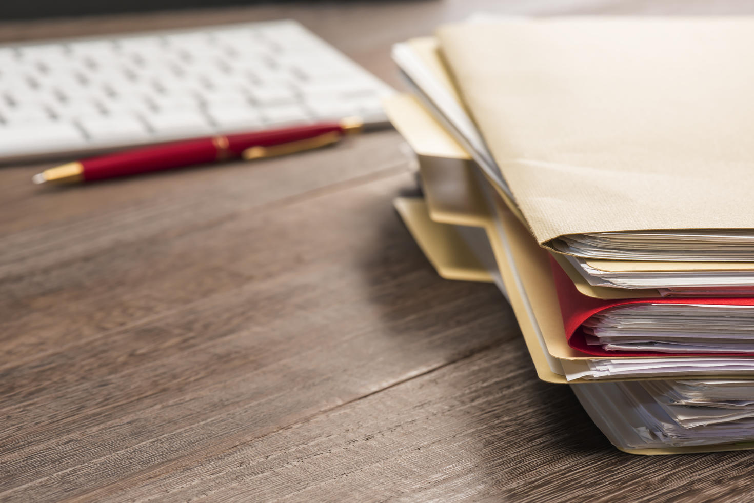 A stack of binders on a table.