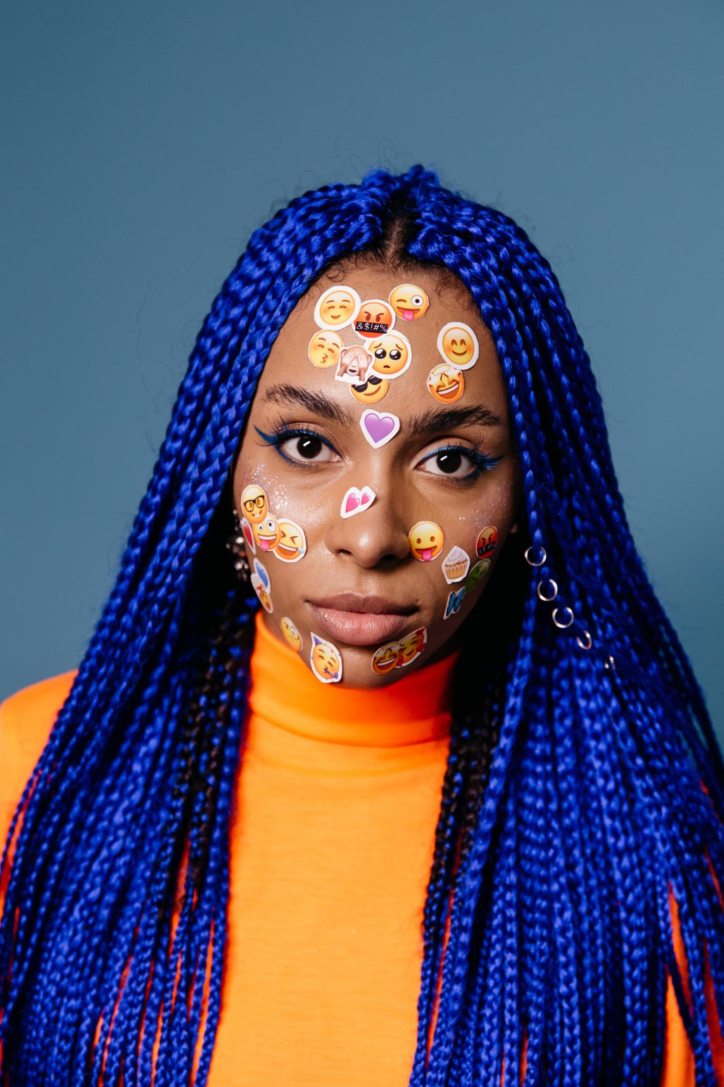 Person with emoji stickers on their face