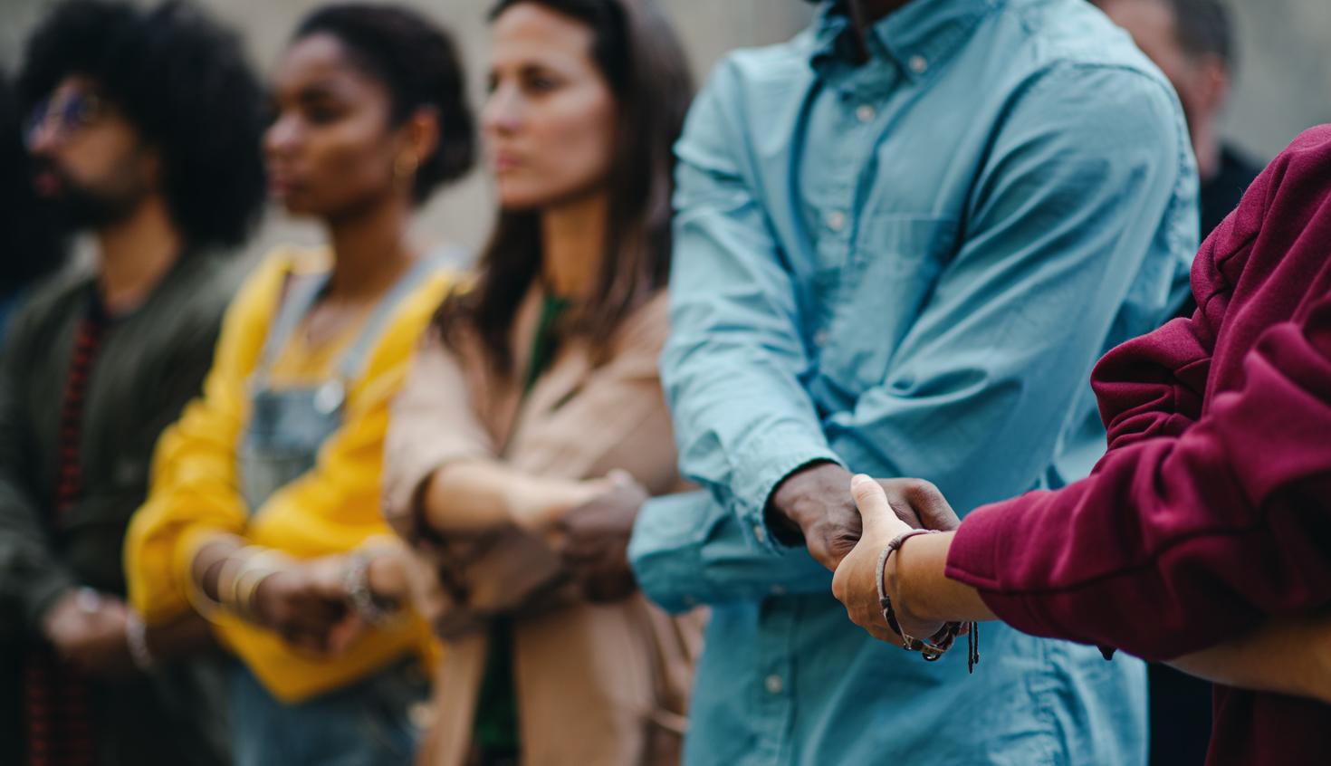 Close-up on people holding there hands, doing an chain