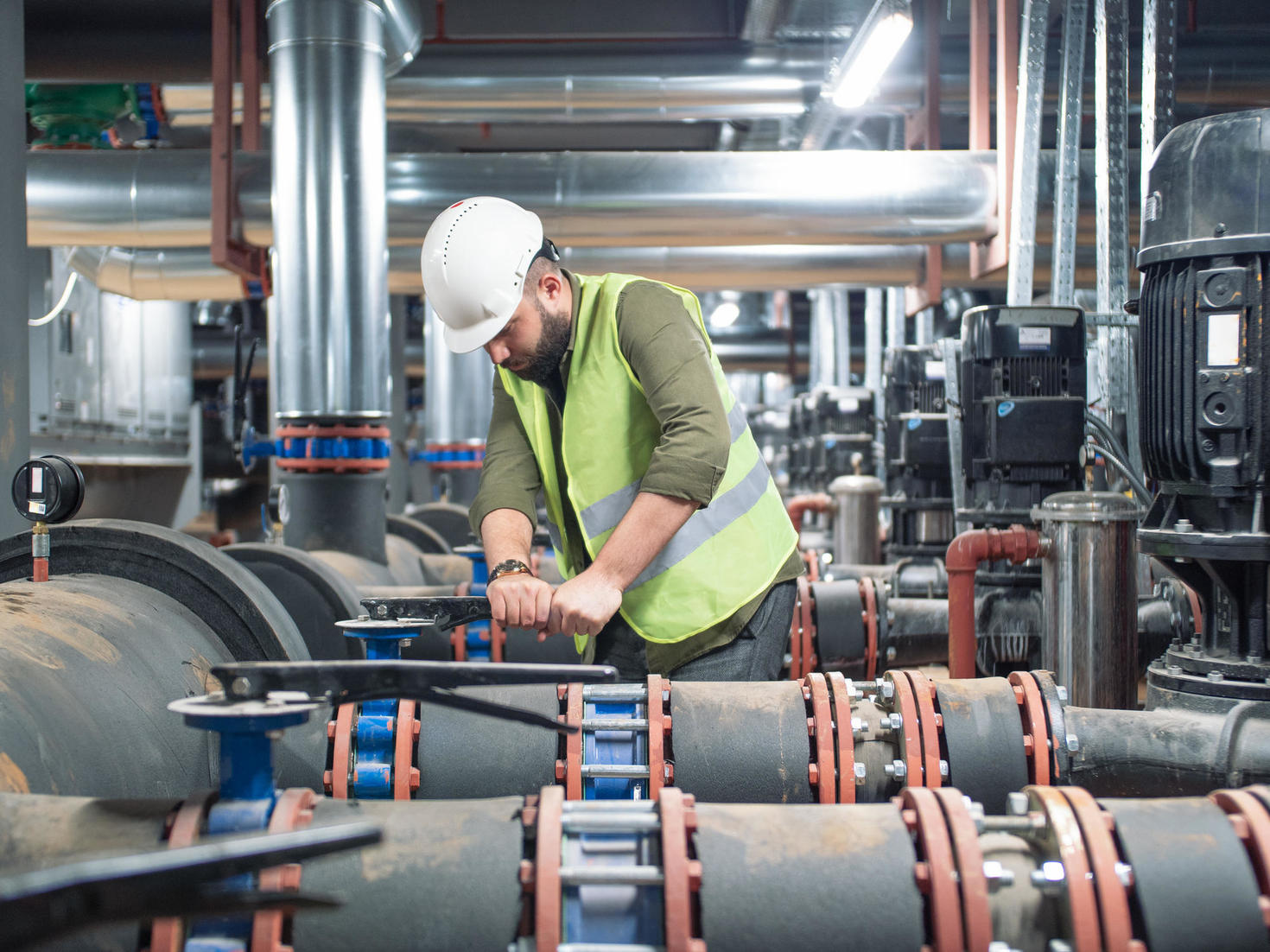 Employee working in mechanical room.