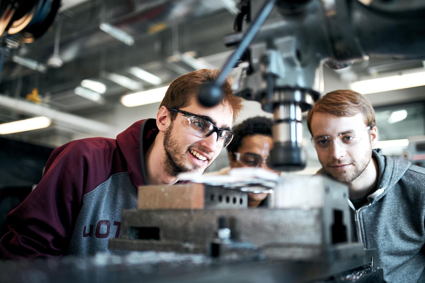 Engineering students working at a table in an engineering lab