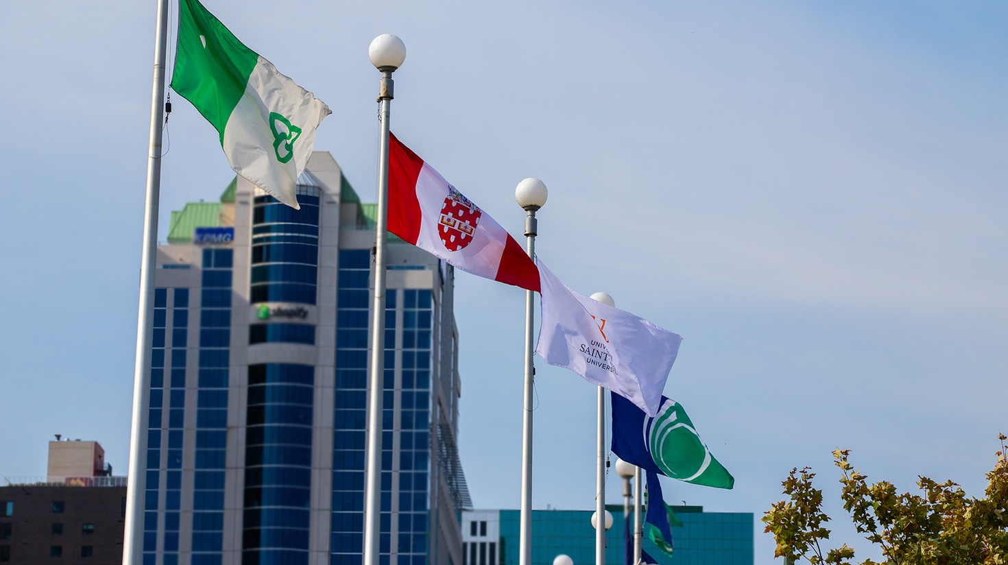 Franco-Ontarian, University of Ottawa, Saint-Paul University and City of Ottawa flags raised outside of Ottawa City Hall.