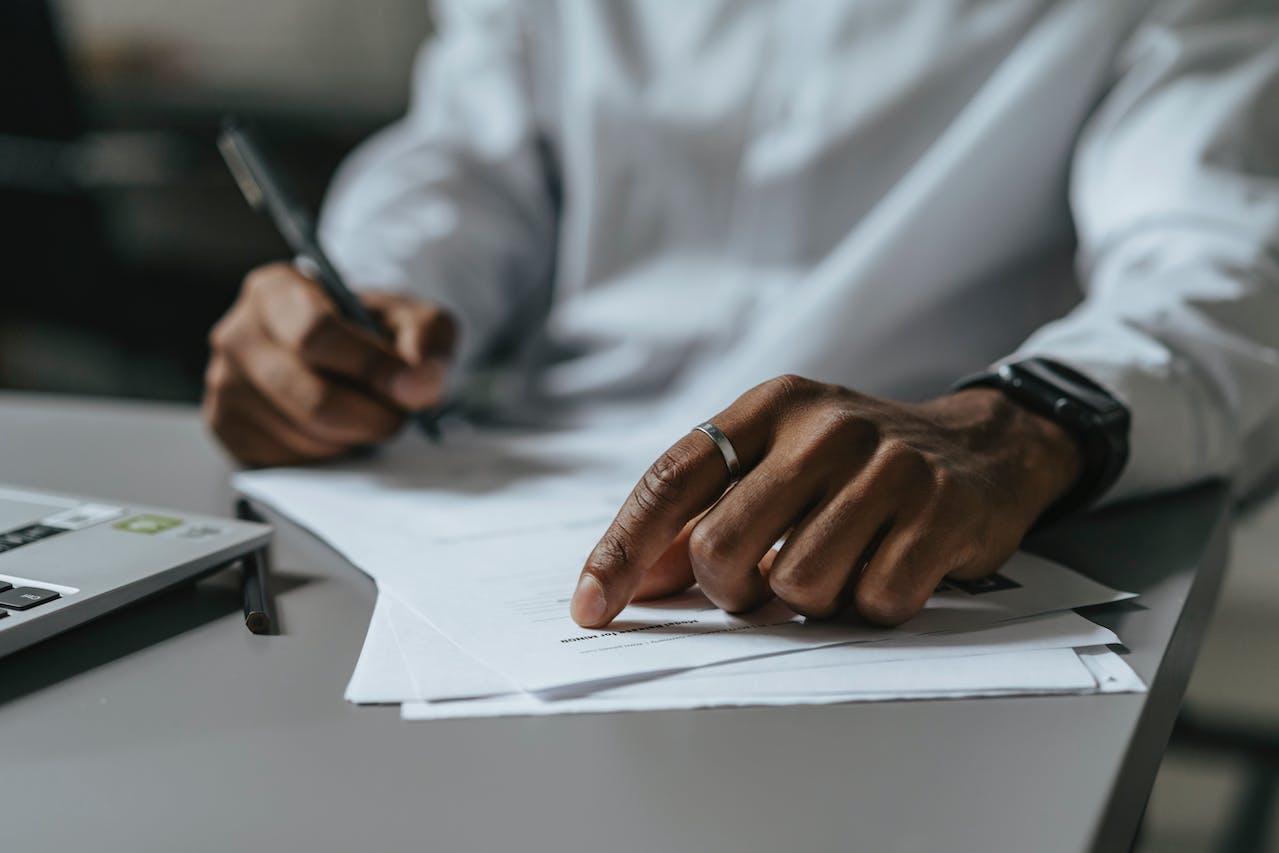 Hand points at document