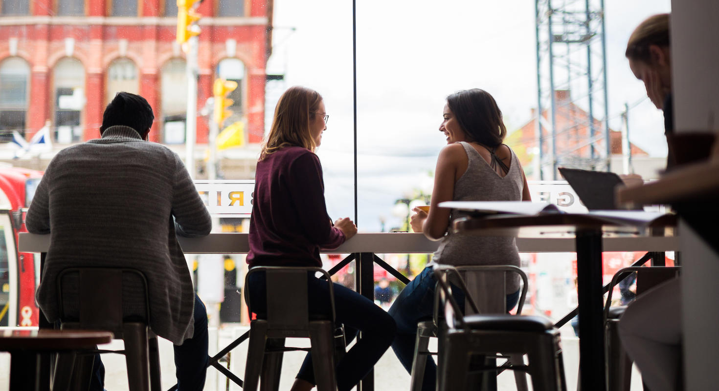 People inside of a cafe working and talking