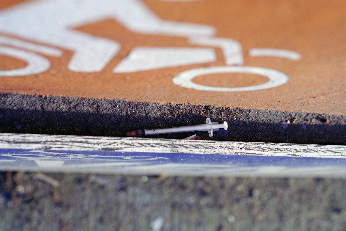 Discarded needle on side of road