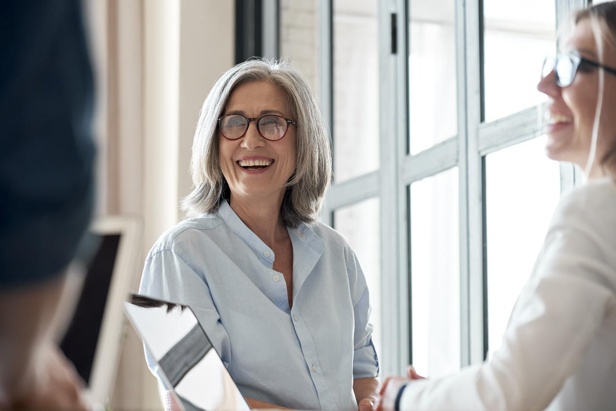older woman smiling at group