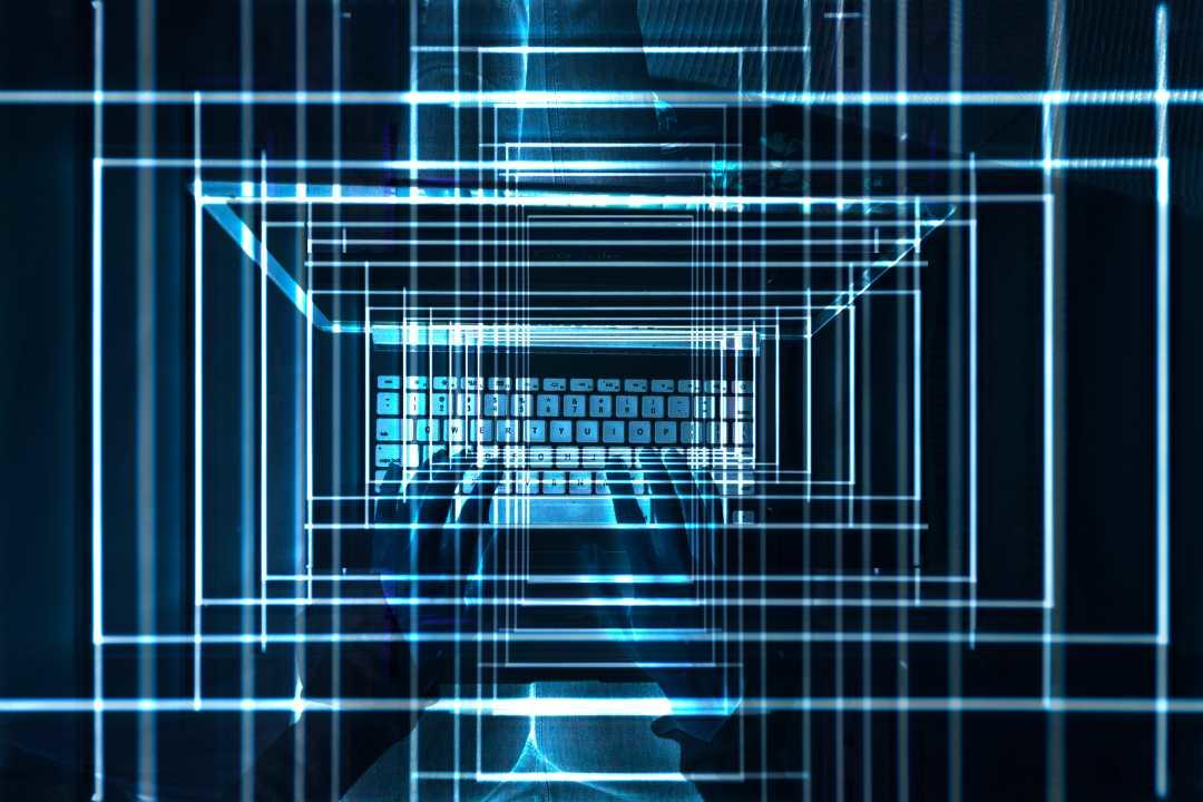 Hands on a laptop whit lights in blue and numbers on s blue dark background
