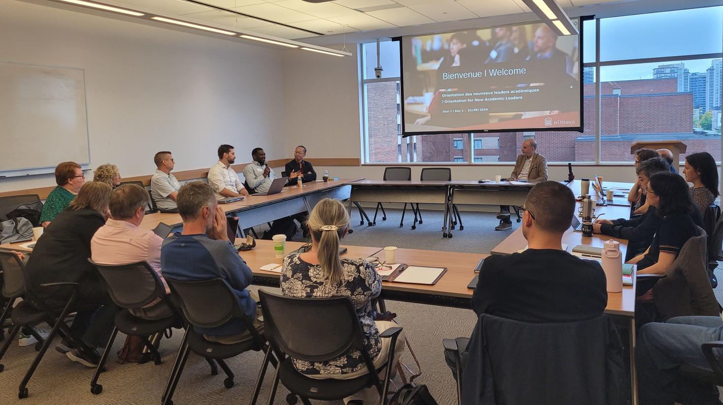 professors in a uOttawa conference room, listening to a speaker