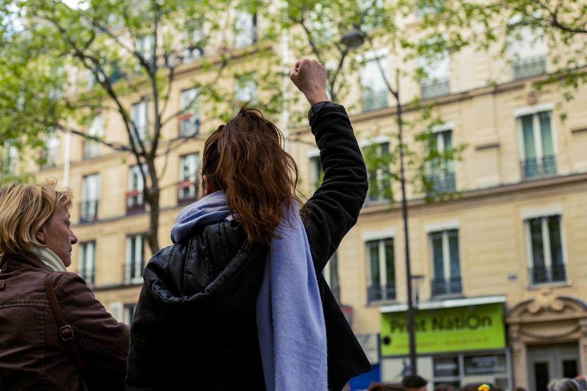 Woman holding fist aloft in show of solidarity