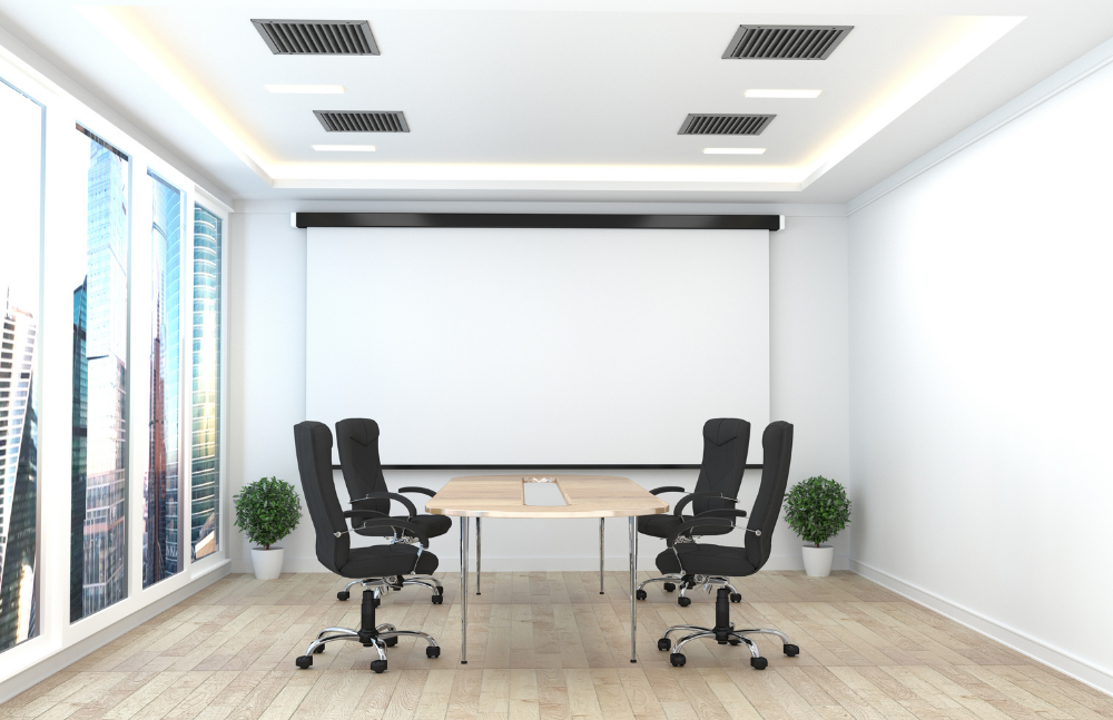 Meeting room with four chair and a giant white board 