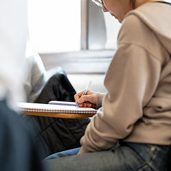 A student sitting at a desk writing