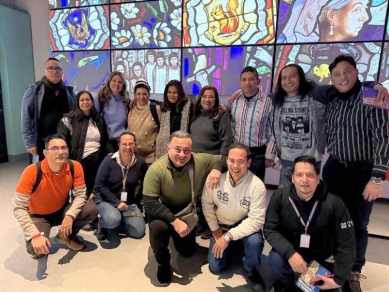 Group in front of stained glass